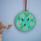 Daisy Chain and Bees Embroidery Hoop Kit on display
